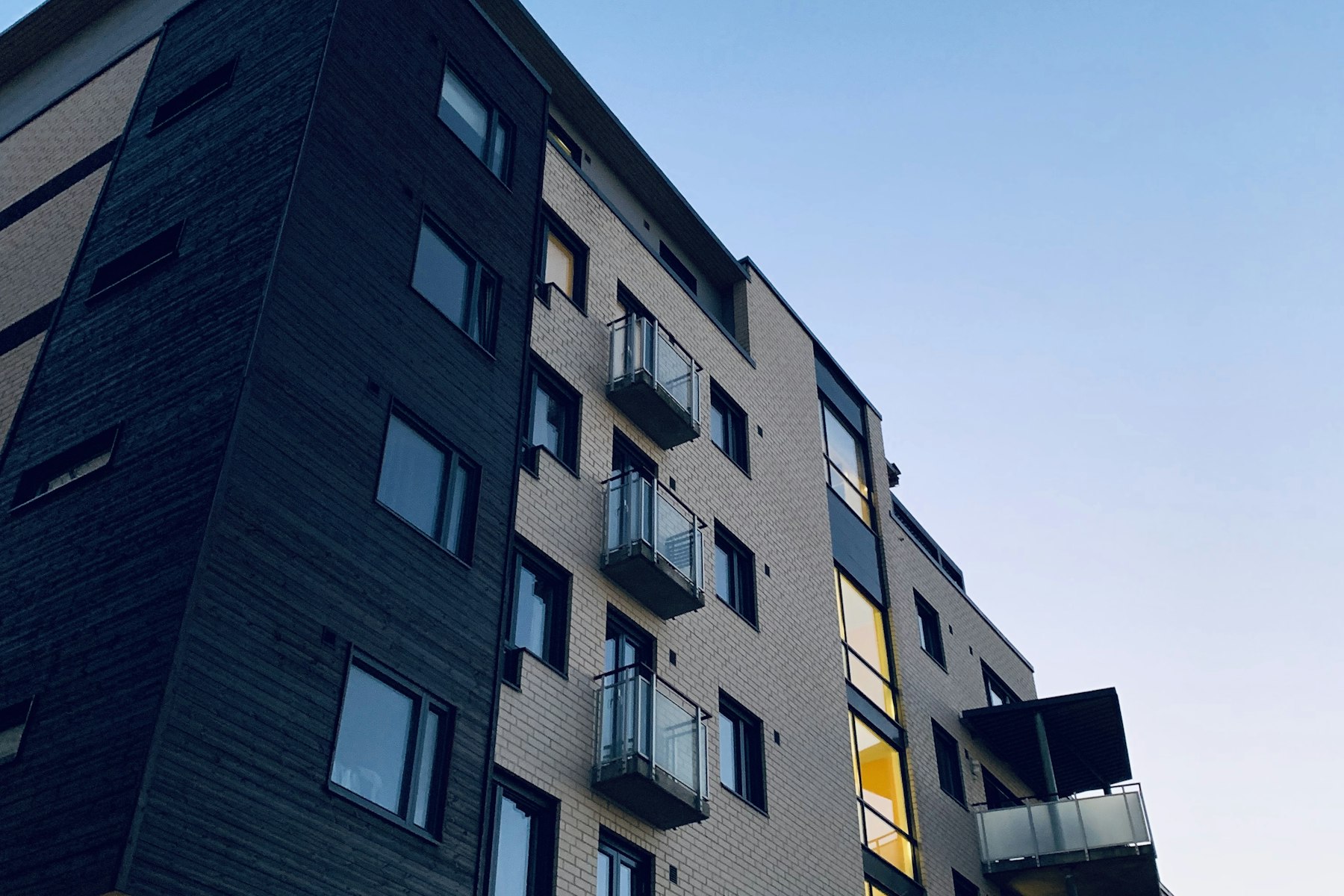 Modern purpose-built apartment block against a clear sky
